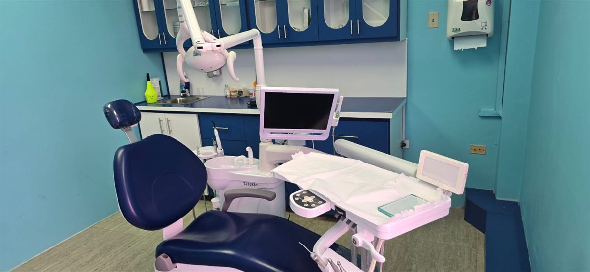 A treatment room at Genesis Dental Care in Crown Point, Tobago, with a modern dental chair and equipment.